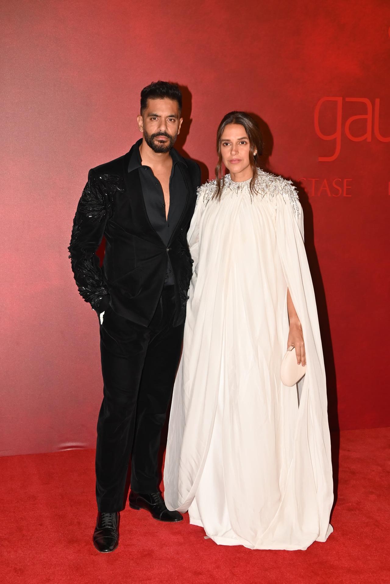 Actors and couple Angad Bedi and Neha Dhupia complemented each other in contrasting colours. While Angad wore a black suit, Neha looked gorgeous in a white gown